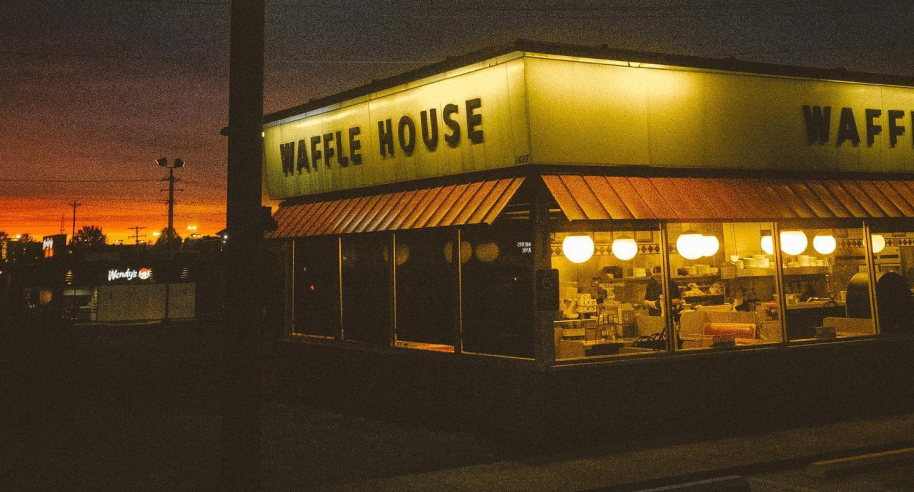 Outside of Tucson Waffle House at night with lights on lighting up the building